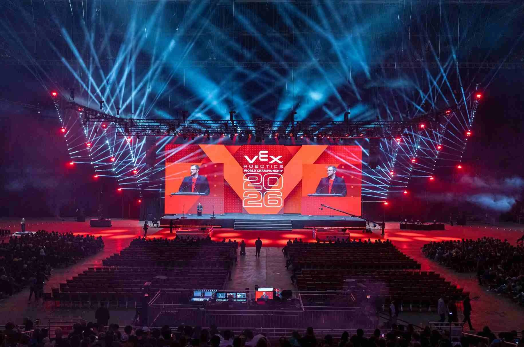 The opening ceremony arena, lit in red and blue, seen from the back of the hall
